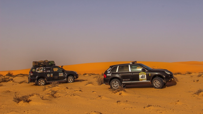 Porsche Cayenne and Toyota Prado 120 LandCruiser in the Sahara